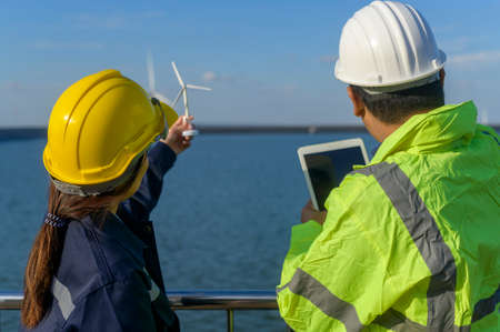 people engineer are wearing a protective helmet on head, using tablet Analytics engineering data.の写真素材