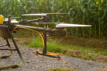 Agriculture drone flying and spraying fertilizer and pesticide over farmland,High technology innovations and smart farmingの写真素材