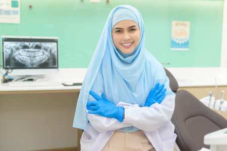 A portrait of female muslim dentist working in dental clinic, teeth check-up and Healthy teeth conceptの写真素材