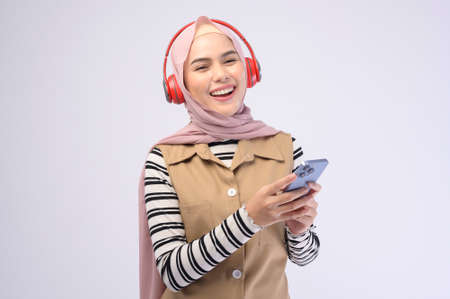 A young beautifu musliml woman wearing headset on white background