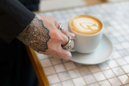 Hot cappuccino with latte art on tableの写真素材
