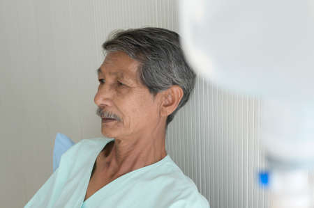 Portrait of senior patient lying on bed in hospital, healthcare and medical conceptの写真素材