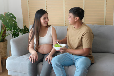 Young pregnant woman having salad at home, healthcare and pregnancy careの写真素材