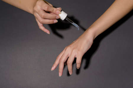 A close up hand of applying moisturizing cream, skincare and beauty conceptの写真素材