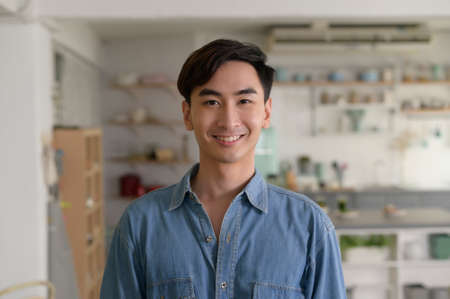 Portrait of young asian man in the living room at home