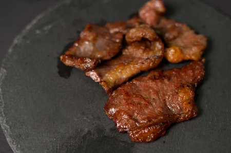 grilled beef on plate over black background studioの写真素材