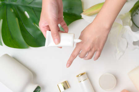 A close up hand of applying moisturizing cream, skincare and beauty conceptの写真素材
