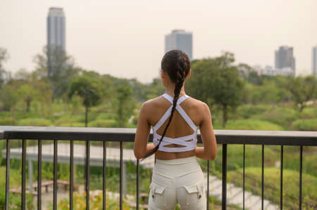 A young fitness woman in sportswear exercising in city park, Healthy and Lifestyles.