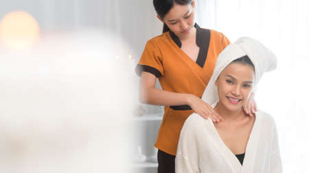 A young asian beautiful woman relaxing and enjoying massage, spa and beauty treatment conceptの写真素材