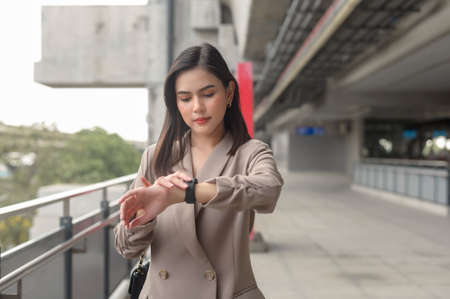 Businesswoman is using Smart watch in Modern city , business technology , city lifestyle conceptの写真素材