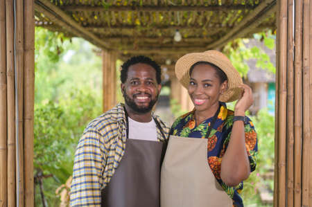 A Happy black agronomist couple enjoying and working in farmland, agriculture conceptの写真素材
