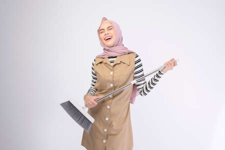 A young muslim beautiful housewife smiling on white background