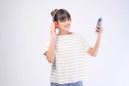 A young beautiful woman wearing headset on white backgroundの写真素材