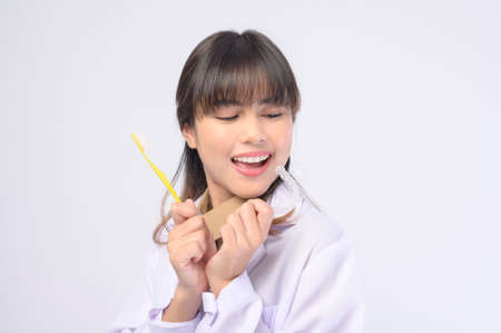 A young female dentist smiling over white background studioの写真素材