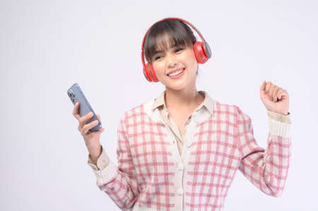 A young beautiful woman wearing headset on white backgroundの写真素材