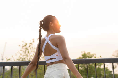 A portrait of young fitness woman in sportswear in city park, Healthy and Lifestyles.