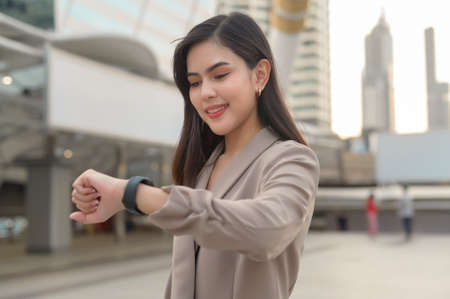 Businesswoman is using Smart watch in Modern city , business technology , city lifestyle conceptの写真素材