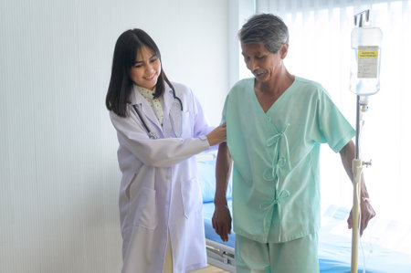Doctor is helping patient senior man with walker at hospital, health care and medical conceptの写真素材