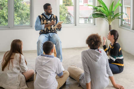 group of students studying and playing with teacher, education and learning concept.