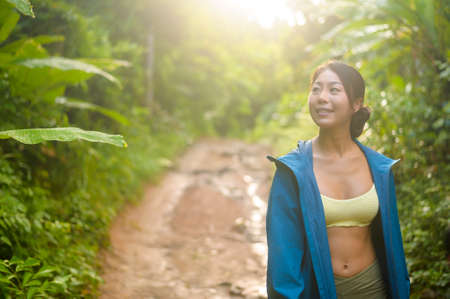 A Beautiful asian woman in sportswear trekking on mountain trail, Travel and ecotourism concept.