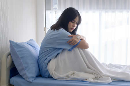 A despondent Asian woman patient. Following the doctor's declaration that the cancer was nearing the...