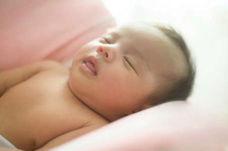 A Young mother with a Cute new born baby.の写真素材