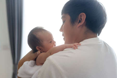 A Young father with a Cute new born baby.