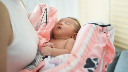 A Young mother with a Cute new born baby.の写真素材