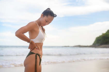 A Young Beautiful woman in Bikini enjoying and relaxing on the beach,  Summer, vacation, holidays,...