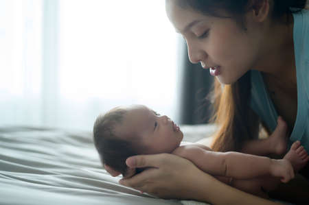 A Young mother with a Cute new born baby.の写真素材