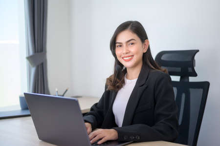A Female call center agent with headset consulting clients online, customer service and customer...