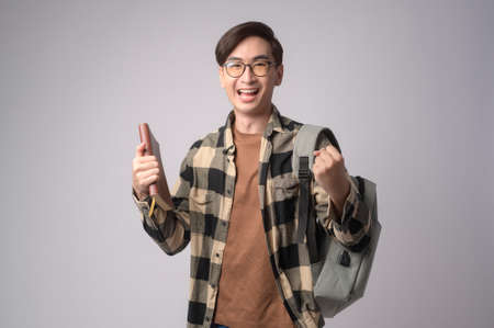 A Portrait of an Asian university student over white background studio, education concept.の写真素材