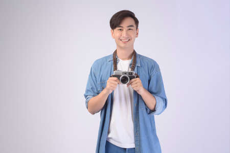 A Young happy asian tourist man over white background studio, travel and holidays concept.の写真素材