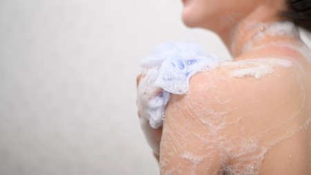 A Happy beautiful woman is taking a showerの写真素材