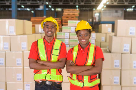A Portrait of mixed race workers wearing helmet in modern warehouse storage of retail shopの写真素材