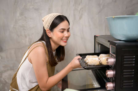 A Young beautiful woman is baking in her kitchen , bakery and coffee shop businessの写真素材