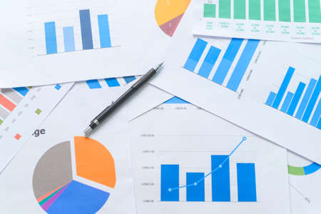 Top view of Documents with analytics data lying on table,selective focus