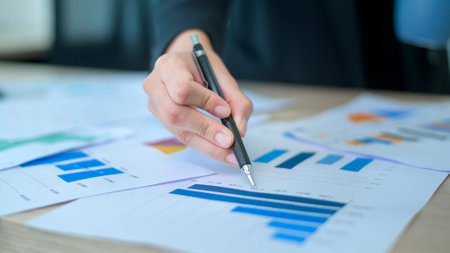 Top view of Documents with analytics data lying on table,selective focus