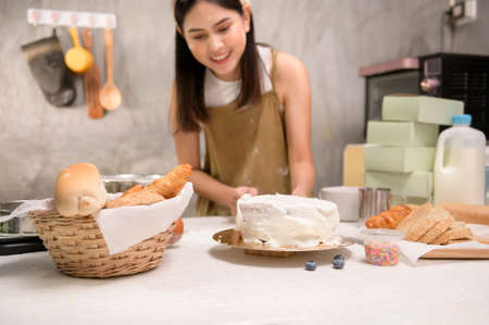 A Young beautiful woman is baking in her kitchen , bakery and coffee shop businessの写真素材