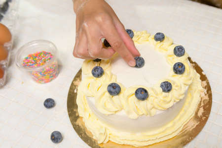 A Close up of Young beautiful woman is baking in her kitchen , bakery and coffee shop businessの写真素材