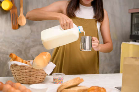 A Close up of Young beautiful woman is baking in her kitchen , bakery and coffee shop businessの写真素材