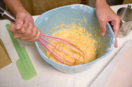A Close up of Young beautiful woman is baking in her kitchen , bakery and coffee shop businessの写真素材