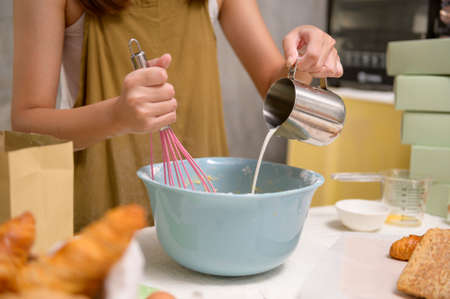 A Close up of Young beautiful woman is baking in her kitchen , bakery and coffee shop businessの写真素材