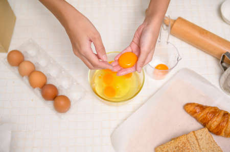 A Close up of Young beautiful woman is baking in her kitchen , bakery and coffee shop businessの写真素材