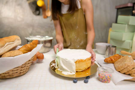 A Close up of Young beautiful woman is baking in her kitchen , bakery and coffee shop businessの写真素材