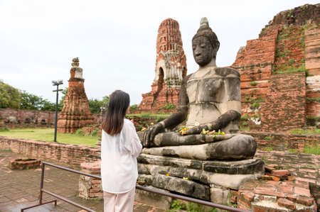 young beautiful woman traveling and taking photo at thai historical Park, Holidays and cultural tourism concept.の写真素材