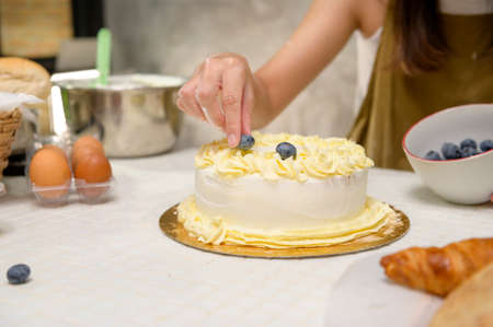 A Close up of Young beautiful woman is baking in her kitchen , bakery and coffee shop business