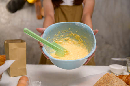 A Close up of Young beautiful woman is baking in her kitchen , bakery and coffee shop business