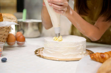A Close up of Young beautiful woman is baking in her kitchen , bakery and coffee shop businessの写真素材