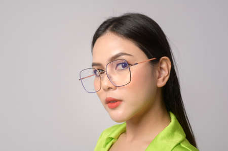 A Portrait of Beautiful woman wearing glasses over white background studio, eyecare concept.